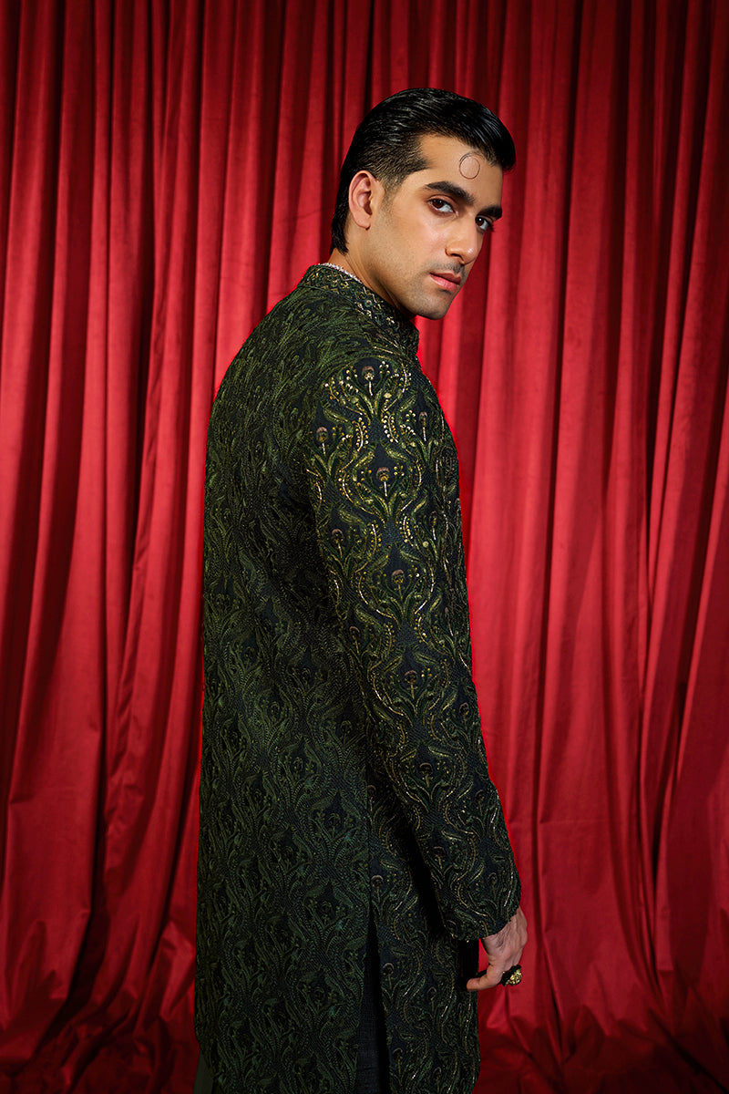 Shop designer embroidered green sherwani for groom with intricate gold detailing, available for online purchase. Perfect traditional attire for weddings and special occasions.