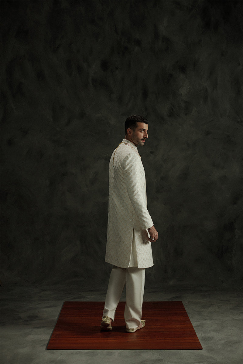 Designer white sherwani for grooms with hand-crafted details