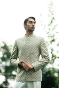 Elegant green prince coat for groom with intricate design details, perfect for a royal wedding look.