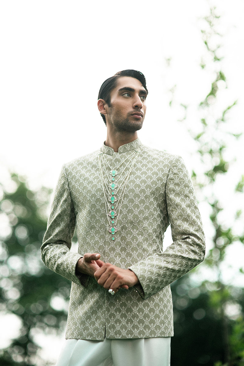 Elegant green prince coat for groom with intricate design details, perfect for a royal wedding look.
